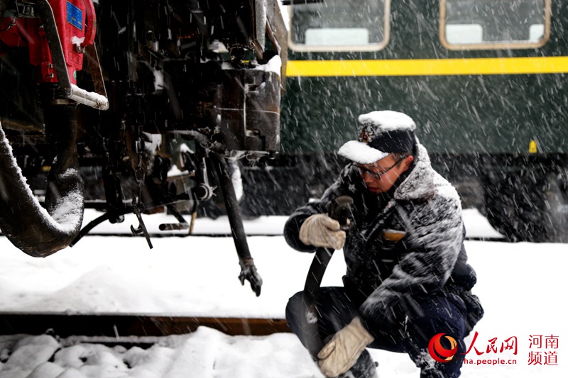 河南大雪致部分列车晚点 三万多名铁路职工扫雪