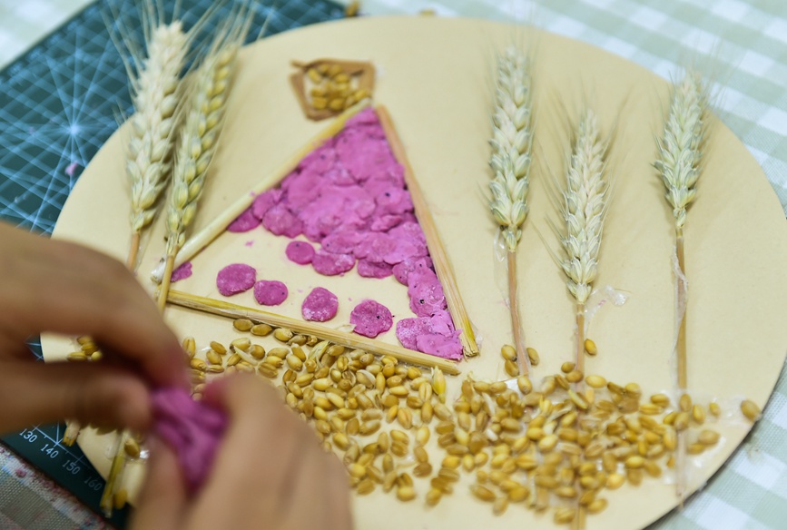 6月5日，小朋友在研學課堂上體驗制作“安苗”芒種習俗麥面畫。黃政偉攝 