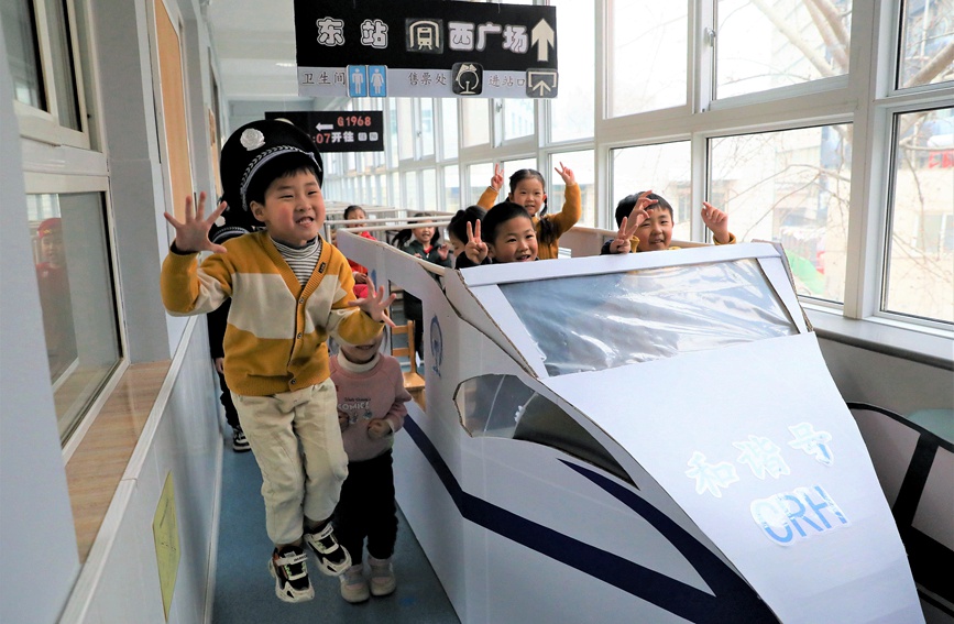 郑州铁路幼儿园开学第一天，小朋友们在老师准备的火车模型内开心的游戏。许伟摄