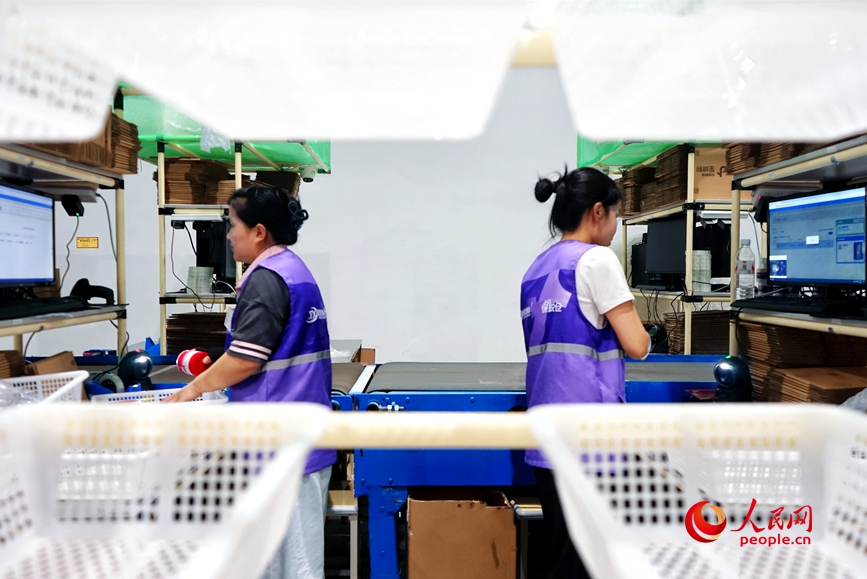 倉儲車間裡，工作人員正在忙碌中。人民網 霍亞平攝