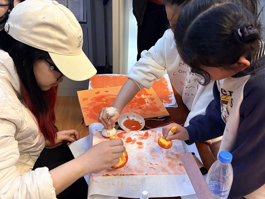 文创体验室内,游客亲手拓印杂技主题图案。贾淼摄